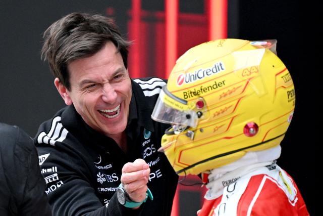 Mercedes' Austrian team principal and CEO Toto Wolff (L) congratulates third-placed Ferrari's British driver Lewis Hamilton after the Formula One Chinese Grand Prix at the Shanghai International Circuit in Shanghai on March 15, 2026. (Photo by GREG BAKER / AFP)