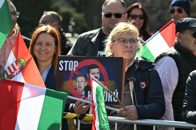 Poeple wave Hungarian national flags and hold banners as they attend a "Peace March" in support of the government of Hungary's Prime Minister on Margaret Bridge in Budapest, Hungary on March 15, 2026, to commemorate the 178th anniversary of the Hungarian Revolution and War of Independence of 1848-1849. The 1848-1849 revolution in the Kingdom of Hungary grew into a war for independence from the Austrian Empire, ruled by the Habsburg dynasty. (Photo by Attila KISBENEDEK / AFP)