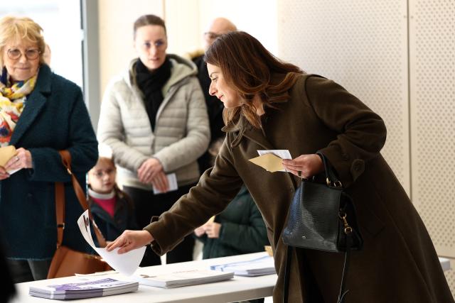 National secretary of French left-wing The Ecologistes party Marine Tondelier picks ballot papers prior to cast her ballot during the first round of France's 2026 municipal elections in Henin-Beaumont, northern France, on March 15, 2026. (Photo by Sameer AL-DOUMY / AFP)