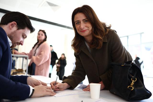 National secretary of French left-wing The Ecologistes party Marine Tondelier signs the register after she cast her ballot during the first round of France's 2026 municipal elections in Henin-Beaumont, northern France, on March 15, 2026. (Photo by Sameer AL-DOUMY / AFP)