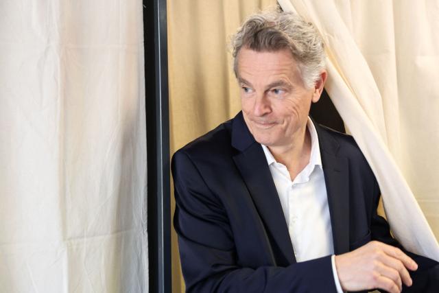 Communist Party (PC) mayoral candidate Fabien Roussel reacts as he exits a polling booth to cast his ballot during the first round of France's 2026 municipal elections in Saint-Amand-les-Eaux, northern France on March 15, 2026. (Photo by Francois LO PRESTI / AFP)