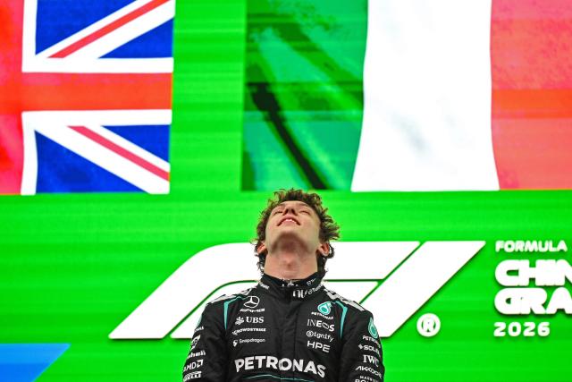 Winner Mercedes' Italian driver Kimi Antonelli celebrates on the podium after the Formula One Chinese Grand Prix at the Shanghai International Circuit in Shanghai on March 15, 2026. (Photo by GREG BAKER / AFP)