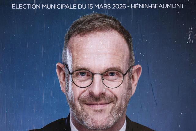A photograph taken on March 15, 2026 shows an a campaign poster picturing Incumbent mayor of Henin-Beaumont and far-right Rassemblement National (RN) party mayoral candidate Steeve Briois during the first round of France's 2026 municipal elections in Henin-Beaumont, northern France. (Photo by Sameer AL-DOUMY / AFP)