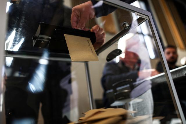 A Local resident casts his ballot during the first round of France's 2026 municipal elections in Lens, northern France, on March 15, 2026. (Photo by Sameer AL-DOUMY / AFP)