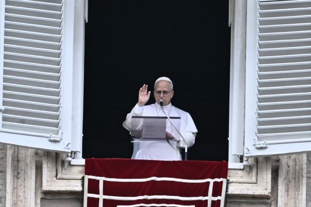 Pope Leo XIV adresses the pilgrims gathered in St. Peter's Square during the Sunday Angelus prayer at the Vatican on March 15, 2026. (Photo by Filippo MONTEFORTE / AFP)