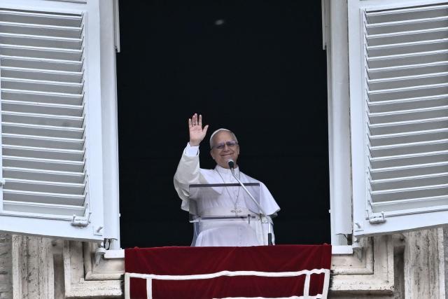 Pope Leo XIV greets the pilgrims gathered in St. Peter's Square during the Sunday Angelus prayer at the Vatican on March 15, 2026. (Photo by Filippo MONTEFORTE / AFP)