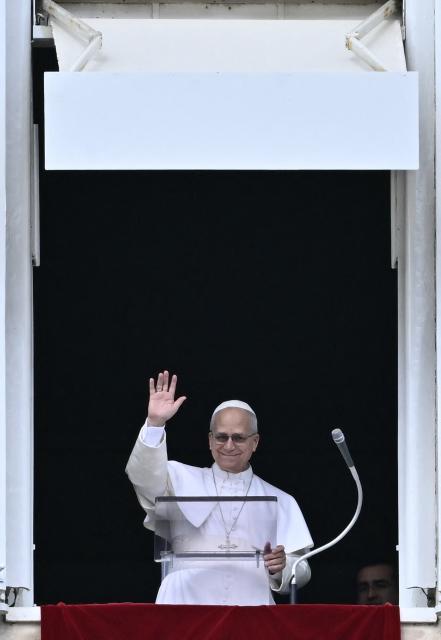 Pope Leo XIV greets the pilgrims gathered in St. Peter's Square during the Sunday Angelus prayer at the Vatican on March 15, 2026. (Photo by Filippo MONTEFORTE / AFP)