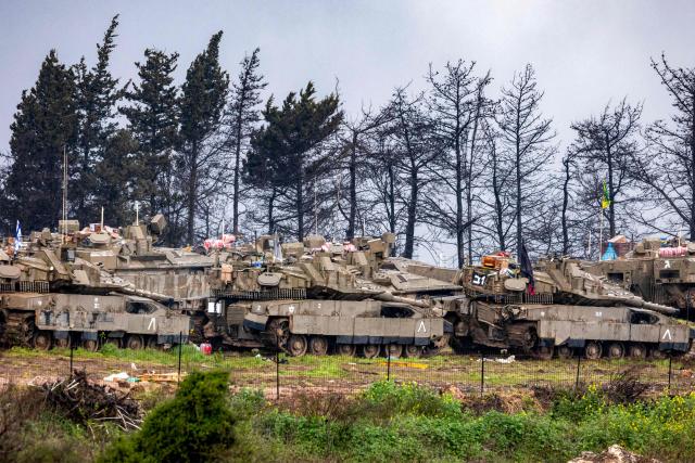 Israeli army tanks deploy at a position in the Upper Galilee in northern Israel near the border with Lebanon on March 15, 2026. Overnight strikes in southern Lebanon killed at least four people, Lebanese state media and the government said on March 15, as Israel said it was pressing its campaign against Iran-backed Hezbollah. According to Lebanon's health ministry, Israeli air strikes have killed 826 people in Lebanon since the start of the latest war, which began March 2 with Hezbollah firing missiles at Israel. (Photo by Odd ANDERSEN / AFP)