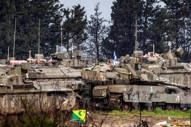 Israeli army tanks deploy at a position in the Upper Galilee in northern Israel near the border with Lebanon on March 15, 2026. Overnight strikes in southern Lebanon killed at least four people, Lebanese state media and the government said on March 15, as Israel said it was pressing its campaign against Iran-backed Hezbollah. According to Lebanon's health ministry, Israeli air strikes have killed 826 people in Lebanon since the start of the latest war, which began March 2 with Hezbollah firing missiles at Israel. (Photo by Odd ANDERSEN / AFP)