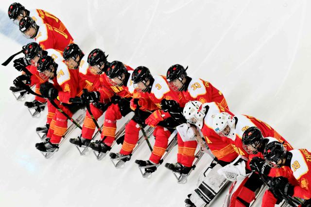 China players line up prior the bronze medal ice hockey match between Czech Republic and China at the Milano Cortina 2026 Paralympic Winter Games in Milan on March 15, 2026. (Photo by Stefano RELLANDINI / AFP)