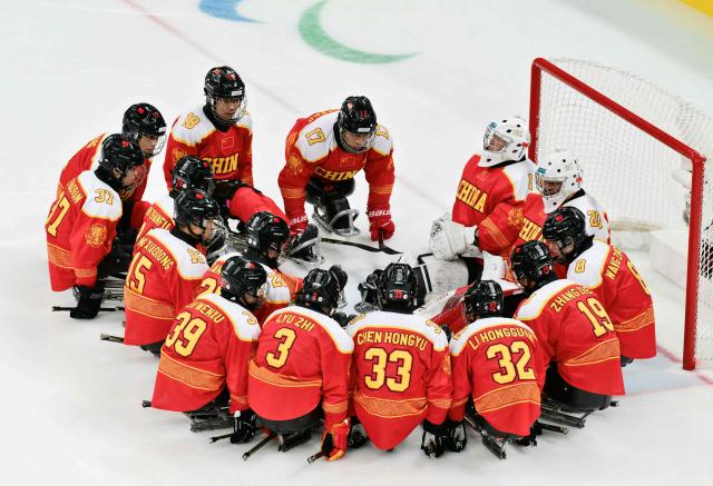 China players concentrate prior the bronze medal ice hockey match between Czech Republic and China at the Milano Cortina 2026 Paralympic Winter Games in Milan on March 15, 2026. (Photo by Stefano RELLANDINI / AFP)