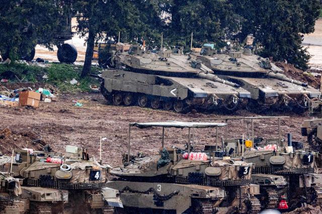 Israeli army tanks deploy at a position in the Upper Galilee in northern Israel near the border with Lebanon on March 15, 2026. Overnight strikes in southern Lebanon killed at least four people, Lebanese state media and the government said on March 15, as Israel said it was pressing its campaign against Iran-backed Hezbollah. According to Lebanon's health ministry, Israeli air strikes have killed 826 people in Lebanon since the start of the latest war, which began March 2 with Hezbollah firing missiles at Israel. (Photo by Odd ANDERSEN / AFP)