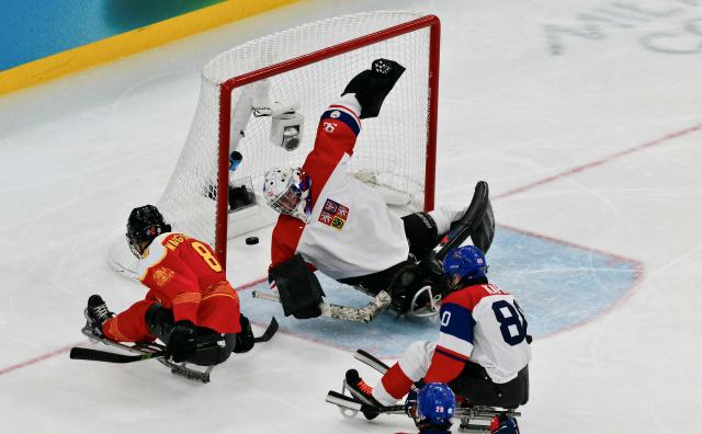 China Wang Zhidong shoots and scores a goal during the bronze medal ice hockey match between Czech Republic and China at the Milano Cortina 2026 Paralympic Winter Games in Milan on March 15, 2026. (Photo by Stefano RELLANDINI / AFP)