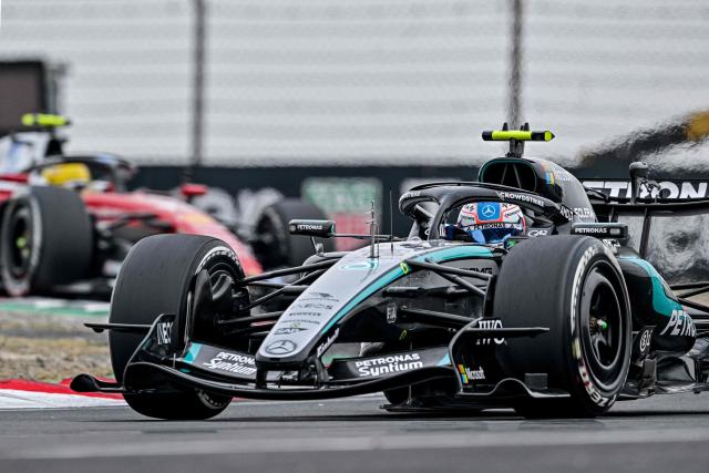 Mercedes' Italian driver Kimi Antonelli drives in front of Ferrari's British driver Lewis Hamilton during the Formula One Chinese Grand Prix at the Shanghai International Circuit in Shanghai on March 15, 2026. (Photo by Hector RETAMAL / AFP)