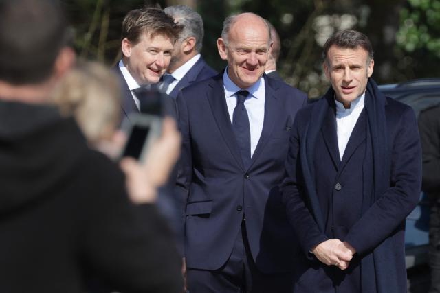 France's President Emmanuel Macron (R) arrives to cast his ballot during the first round of France's 2026 municipal elections in Le Touquet, northern France, on March 15, 2026. (Photo by Ludovic MARIN / AFP)