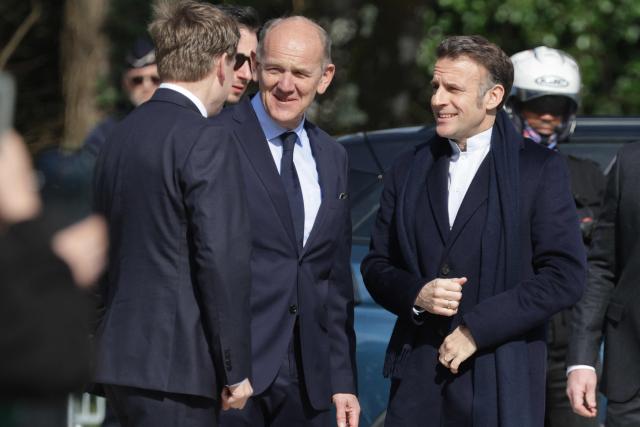 France's President Emmanuel Macron (R) arrives to cast his ballot during the first round of France's 2026 municipal elections in Le Touquet, northern France, on March 15, 2026. (Photo by Ludovic MARIN / AFP)