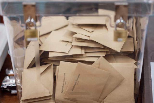 Ballot papers are seen in a ballot box at a polling station during the first round of France's 2026 municipal elections in Menton, southeastern France, on March 15, 2026. (Photo by Frederic DIDES / AFP)