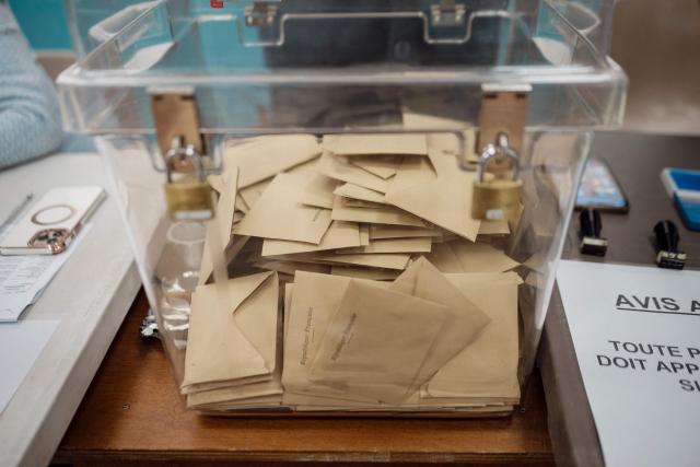 Ballot papers are seen in a ballot box at a polling station during the first round of France's 2026 municipal elections in Menton, southeastern France, on March 15, 2026. (Photo by Frederic DIDES / AFP)