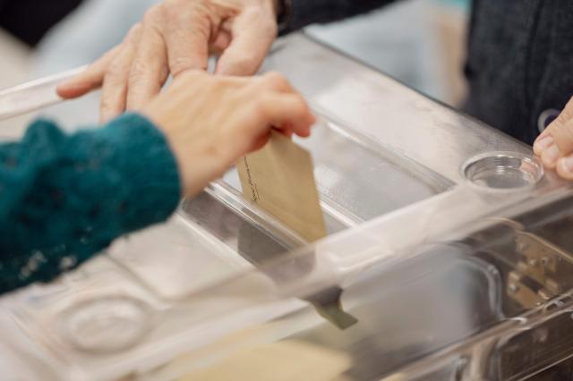 A voter casts a ballot at a polling station during the first round of France's 2026 municipal elections in Menton, southeastern France, on March 15, 2026. (Photo by Frederic DIDES / AFP)