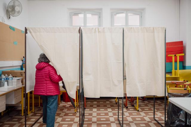 A voter enters a polling booth at a polling station during the first round of France's 2026 municipal elections in Menton, southeastern France, on March 15, 2026. (Photo by Frederic DIDES / AFP)