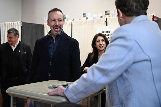 Beziers' far-right Rassemblement National (RN) party mayoral candidate Julien Gabarron visits a polling station during the first round of France's 2026 municipal elections in Beziers, southern France, on March 15, 2026. (Photo by Gabriel BOUYS / AFP)