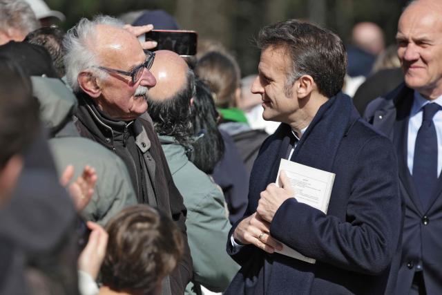 France's President Emmanuel Macron (2ndR) speaks with inhabitatns as he arrives to vote during the first round of France's 2026 municipal elections in Le Touquet, northern France, on March 15, 2026. (Photo by Ludovic MARIN / AFP)