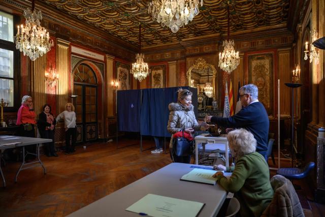 A voters casts her ballot during the first round of France's 2026 municipal elections at the city hall in Perpignan, southwestern France, on March 15, 2026. (Photo by Ed JONES / AFP)