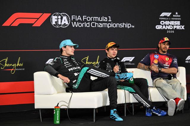Winner Mercedes' Italian driver Kimi Antonelli (R), second-placed Mercedes' British driver George Russell (L) and third-placed Ferrari's British driver Lewis Hamilton attend a press conference after the Formula One Chinese Grand Prix at the Shanghai International Circuit in Shanghai on March 15, 2026. (Photo by Jade GAO / AFP)