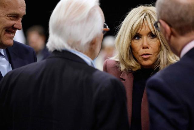 France's first lady Brigitte Macron talks with inhabitants as she arrives to vote for the first round of France's 2026 municipal elections in Le Touquet, northern France, on March 15, 2026. (Photo by Jean-Francois Badias / POOL / AFP)