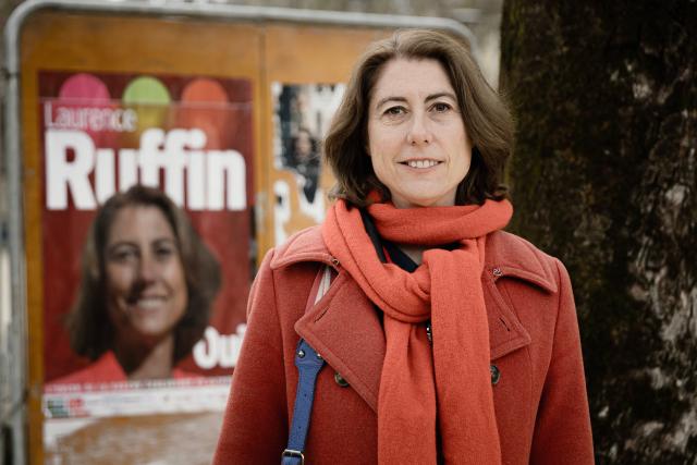 Green Party and left-wing alliance mayoral candidate for Grenoble Laurence Ruffin poses near a campaign poster during the first round of France's 2026 municipal elections in Grenoble, southeastern France, on March 15, 2026. (Photo by Maxime GRUSS / AFP)