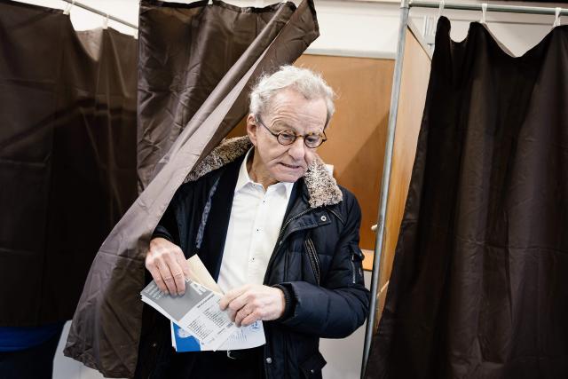 Former Mayor of Grenoble and right-wing Les Republicains (LR) party candidate for his re-election Alain Carignon leaves the polling booth to cast his ballot during the first round of France's 2026 municipal elections in Grenoble, central France on March 15, 2026. (Photo by Maxime GRUSS / AFP)