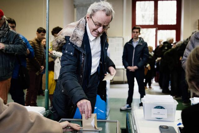 Former Mayor of Grenoble and right-wing Les Republicains (LR) party candidate for his re-election Alain Carignon casts his ballot during the first round of France's 2026 municipal elections in Grenoble, central France on March 15, 2026. (Photo by Maxime GRUSS / AFP)