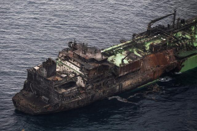 This aerial photo taken on March 15, 2026 shows the wreck of Russian liquified natural gas (LNG) carrier Arctic Metagaz, which is adrift between Malta and Lampedusa. The vessel, which was hit by "sudden explosions followed by a massive fire" according to Libyan port authority, was sanctioned by the United States and the European Union for being one of Russia's so-called "shadow fleet" of ageing tankers that carry its oil and gas around the world, skirting Western restrictions. Russian President Vladimir Putin accused Kyiv of having carried out a "terrorist attack" on the Arctic Metagaz. All 30 crew members were rescued, Moscow said. (Photo by Matthew XUEREB / Newsbook Malta / AFP)