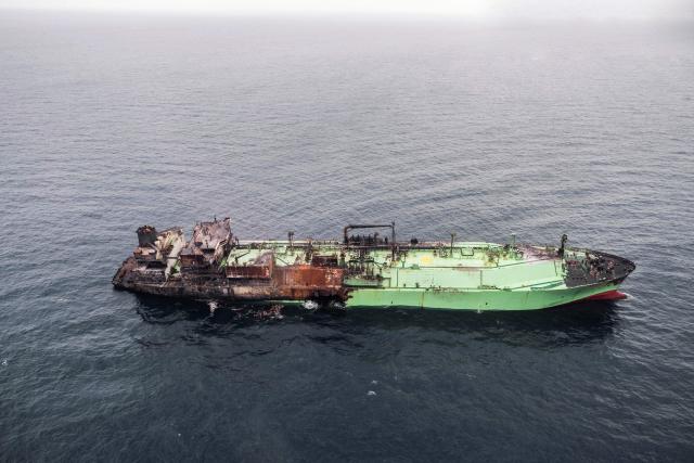 This aerial photo taken on March 15, 2026 shows the wreck of Russian liquified natural gas (LNG) carrier Arctic Metagaz, which is adrift between Malta and Lampedusa. The vessel, which was hit by "sudden explosions followed by a massive fire" according to Libyan port authority, was sanctioned by the United States and the European Union for being one of Russia's so-called "shadow fleet" of ageing tankers that carry its oil and gas around the world, skirting Western restrictions. Russian President Vladimir Putin accused Kyiv of having carried out a "terrorist attack" on the Arctic Metagaz. All 30 crew members were rescued, Moscow said. (Photo by Matthew XUEREB / Newsbook Malta / AFP)