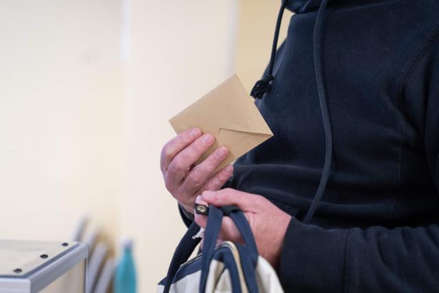 A resident holds a ballot during the first round of France's 2026 municipal elections at a polling station in Lille, northern France, on March 15, 2026. (Photo by Elise HOUBEN / AFP)