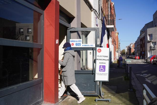 A resident enters a polling station during the first round of France's 2026 municipal elections at a polling station in Lille, northern France, on March 15, 2026. (Photo by Elise HOUBEN / AFP)