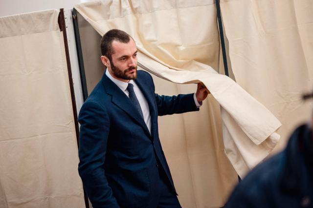 Menton's right-wing coalition "Renouveau Mentonnais" (Menton Revival) mayoral candidate, Louis Sarkozy leaves the polling booth before casting his ballot during the first round of France's 2026 municipal elections in Menton, southeastern France on March 15, 2026. (Photo by Frederic DIDES / AFP)