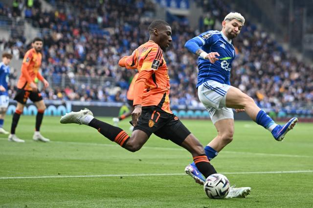 Paris FC's French midfielder #17 Adama Camara (C) fights for the ball with Strasbourg’s Paraguayan midfielder #19 Julio Enciso (R)during the French L1 football match between RC Strasbourg Alsace and Paris FC at the Stade de la Meinau in Strasbourg, eastern France on March 15, 2026. (Photo by SEBASTIEN BOZON / AFP)