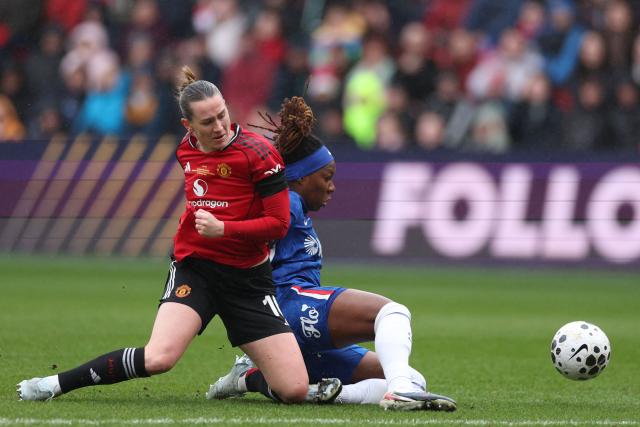 Manchester United's Norwegian striker #10 Elisabeth Terland (L) vies with Chelsea's Canadian defender #26 Kadeisha Buchanan (R) during the English Women's League Cup final football match between Chelsea and Manchester United at Ashton Gate stadium in Bristol, south-west England on March 15, 2026. (Photo by Adrian Dennis / AFP)