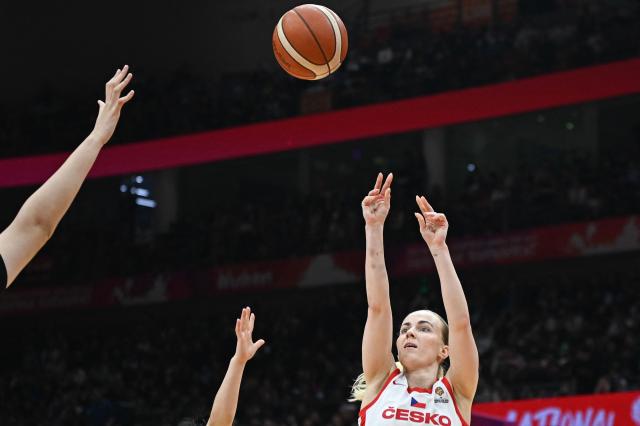 Czech Republic's Petra Holesinska (R) shoots under the pressure of China's players during the FIBA Women's Basketball World Cup 2026 qualifying tournament game between China and Czech Republic in Wuhan, in China's central Hubei province, on March 15, 2026. (Photo by CN-STR / AFP) / China OUT