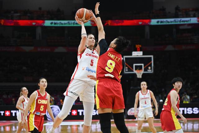 Czech Republic's Natalie Stoupalova (L) is blocked by China's Ziting Tang during the FIBA Women's Basketball World Cup 2026 qualifying tournament game between China and Czech Republic in Wuhan, in China's central Hubei province, on March 15, 2026. (Photo by CN-STR / AFP) / China OUT