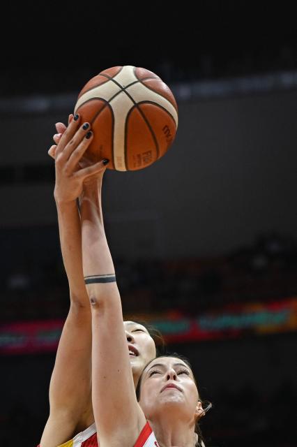 China's Xu Han (L) and Czech Republic's Natalie Stoupalova compete for the ball during the FIBA Women's Basketball World Cup 2026 qualifying tournament game between China and Czech Republic in Wuhan, in China's central Hubei province, on March 15, 2026. (Photo by CN-STR / AFP) / China OUT