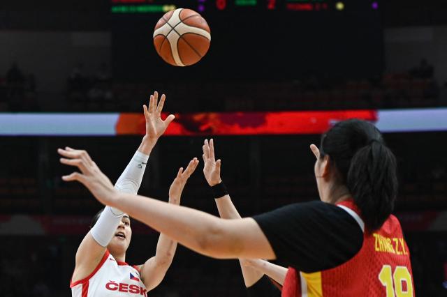 Czech Republic's Eliska Hamzova (L) shoots under the pressure of China's Shuyu Yang and Ziyu Zhang (R) during the FIBA Women's Basketball World Cup 2026 qualifying tournament game between China and Czech Republic in Wuhan, in China's central Hubei province, on March 15, 2026. (Photo by CN-STR / AFP) / China OUT