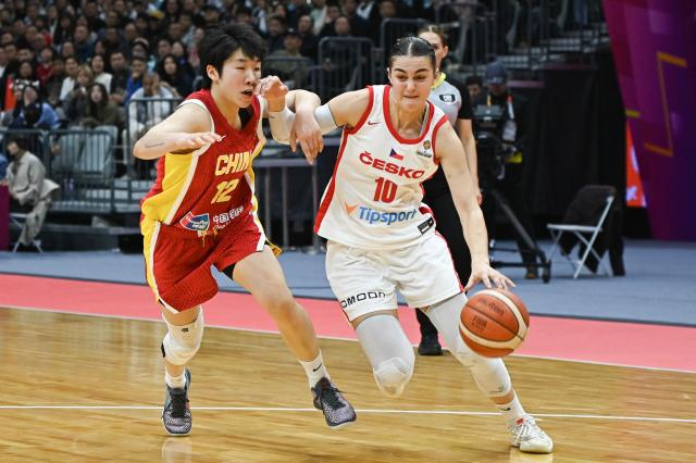 Czech Republic's Eliska Hamzova (R) dribbles the ball while challenged by China's Yujie Chen during the FIBA Women's Basketball World Cup 2026 qualifying tournament game between China and Czech Republic in Wuhan, in China's central Hubei province, on March 15, 2026. (Photo by CN-STR / AFP) / China OUT