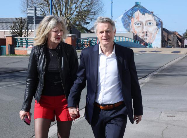 Communist Party (PC) mayoral candidate Fabien Roussel arrives with his wife to vote for the first round of France's 2026 municipal elections in Saint-Amand-les-Eaux, northern France on March 15, 2026. (Photo by Francois LO PRESTI / AFP)