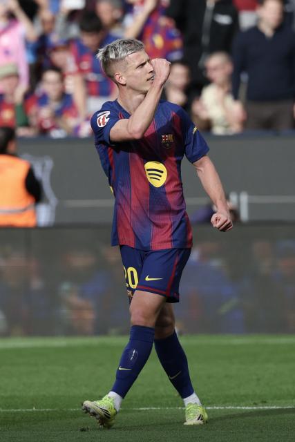 Barcelona's Spanish midfielder #20 Daniel Olmo celebrates scoring his team's third goal during the Spanish League football match between FC Barcelona and Sevilla FC at the Camp Nou Stadium in Barcelona, on March 15, 2026. (Photo by Lluis GENE / AFP)