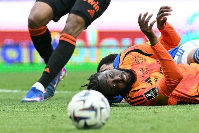 Paris FC’s Ivorian forward #11 Jean-Philippe Krasso eyes the ball during the French L1 football match between RC Strasbourg Alsace and Paris FC at the Stade de la Meinau in Strasbourg, eastern France on March 15, 2026. (Photo by SEBASTIEN BOZON / AFP)