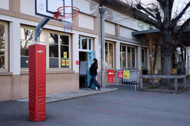 A resident enters a polling station during the first round of France's 2026 municipal elections at a polling station in Villeurbanne, central-eastern France, on March 15, 2026. (Photo by Alex MARTIN / AFP)