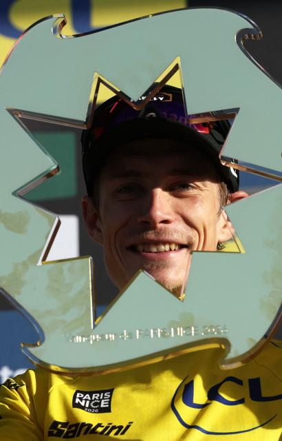 Team Visma - Lease a Bike's Danish rider Jonas Vingegaard celebrates with the trophy after winning the 2026 Paris-Nice cycling race, on March 15, 2026. (Photo by Anne-Christine POUJOULAT / AFP)
