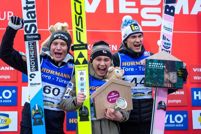 (L-R) Second placed Slovenia's Anze Lanisek, winner Japan's Tomofumi Naito and third placed Finland's Antti Aalto celebrate on the podium after the men's Individual Large Hill at the FIS Jumping World Cup in Holmenkollen, Oslo, Norway on March 15, 2026. (Photo by Terje Pedersen / NTB / AFP) / Norway OUT